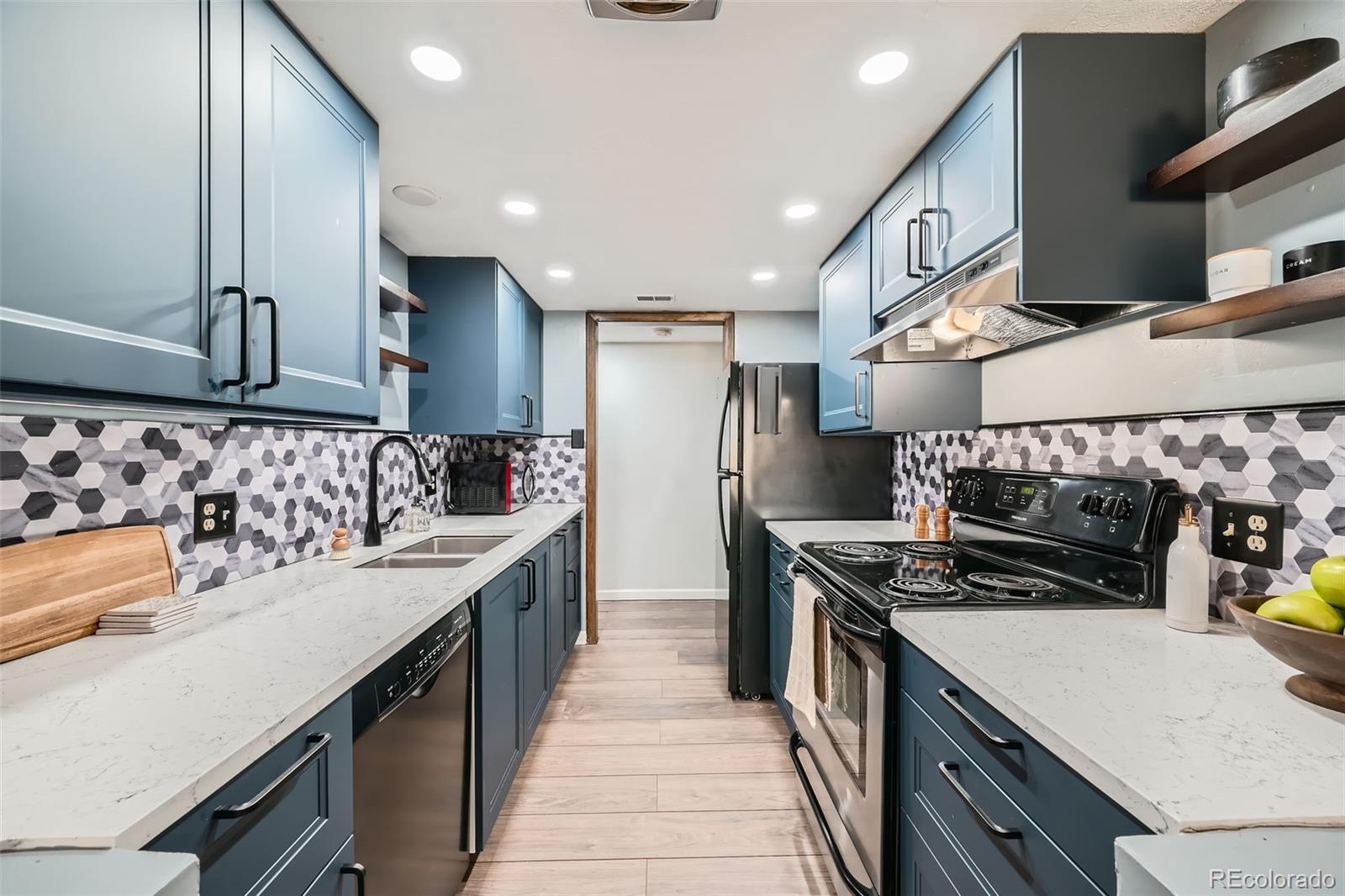 2525 South Dayton Way, Unit 1003 Denver, CO 80231 - Photo 8 of 22 a kitchen with stainless steel appliances a sink stove and cabinets
