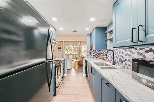 a kitchen with stainless steel appliances granite countertop a sink and stove