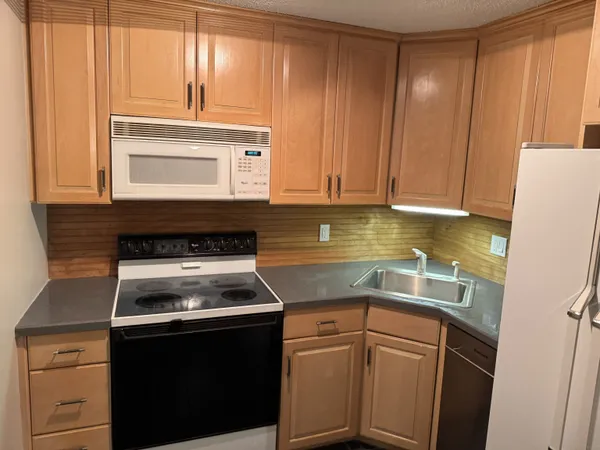 a kitchen with a stove microwave and cabinets