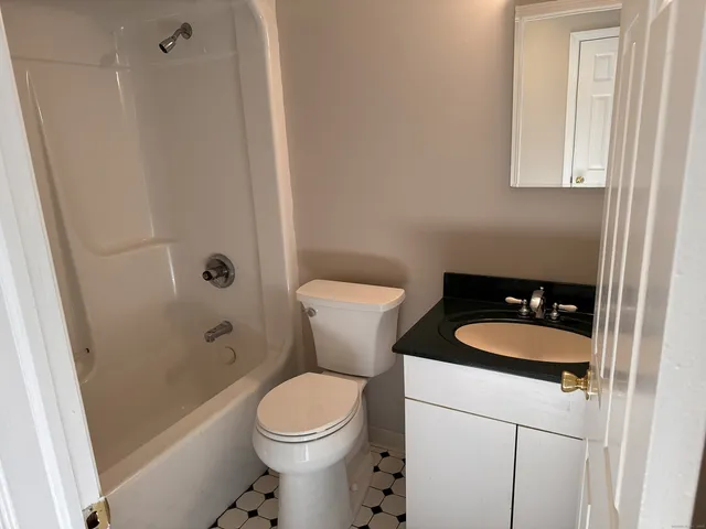 a bathroom with a toilet a sink and a shower