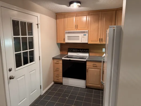 a kitchen with a refrigerator stove and cabinets