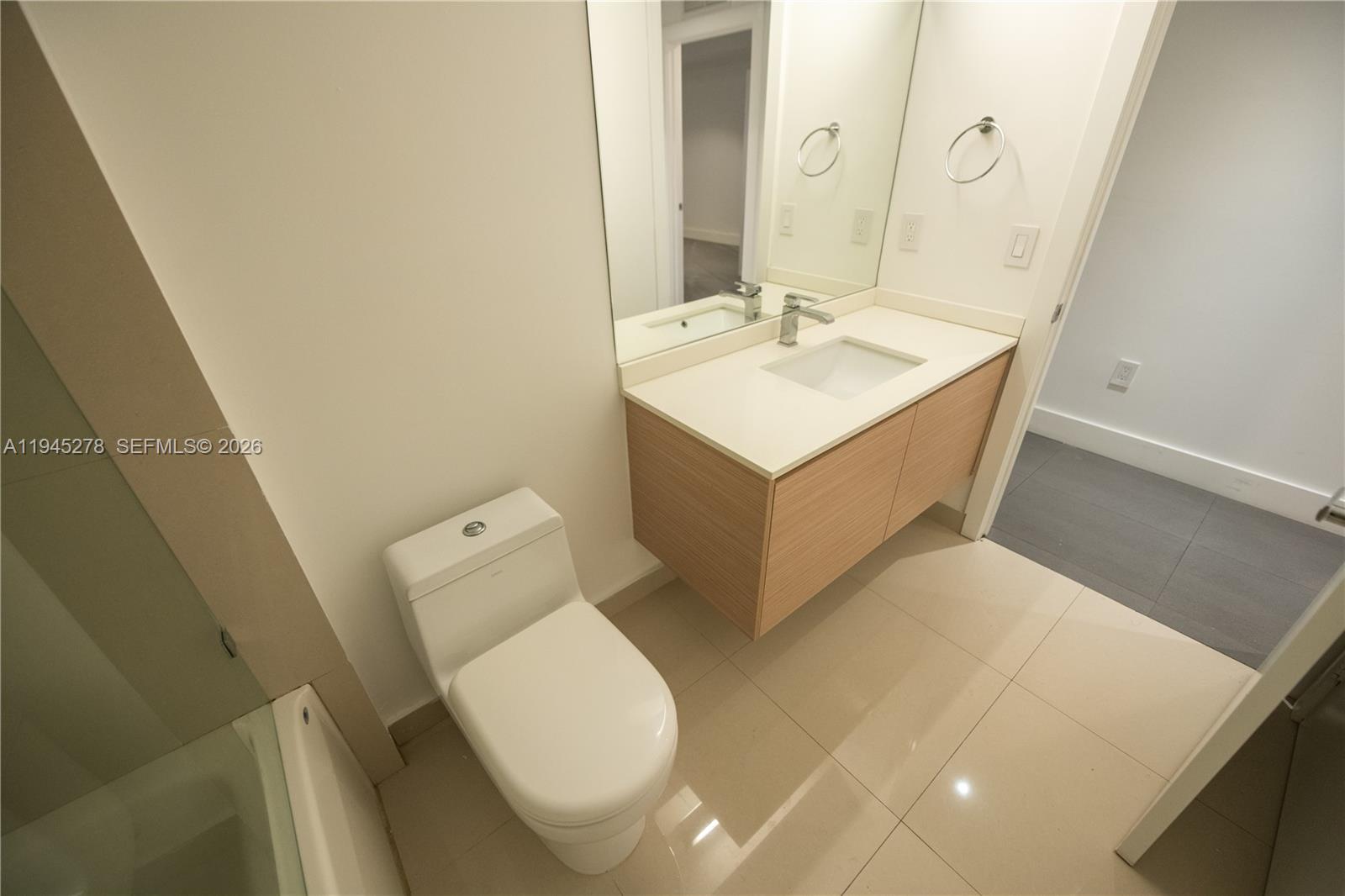 600 Northeast 27th Street, Unit 1602 Miami, FL 33137 - Photo 21 of 34 a bathroom with a sink toilet and mirror