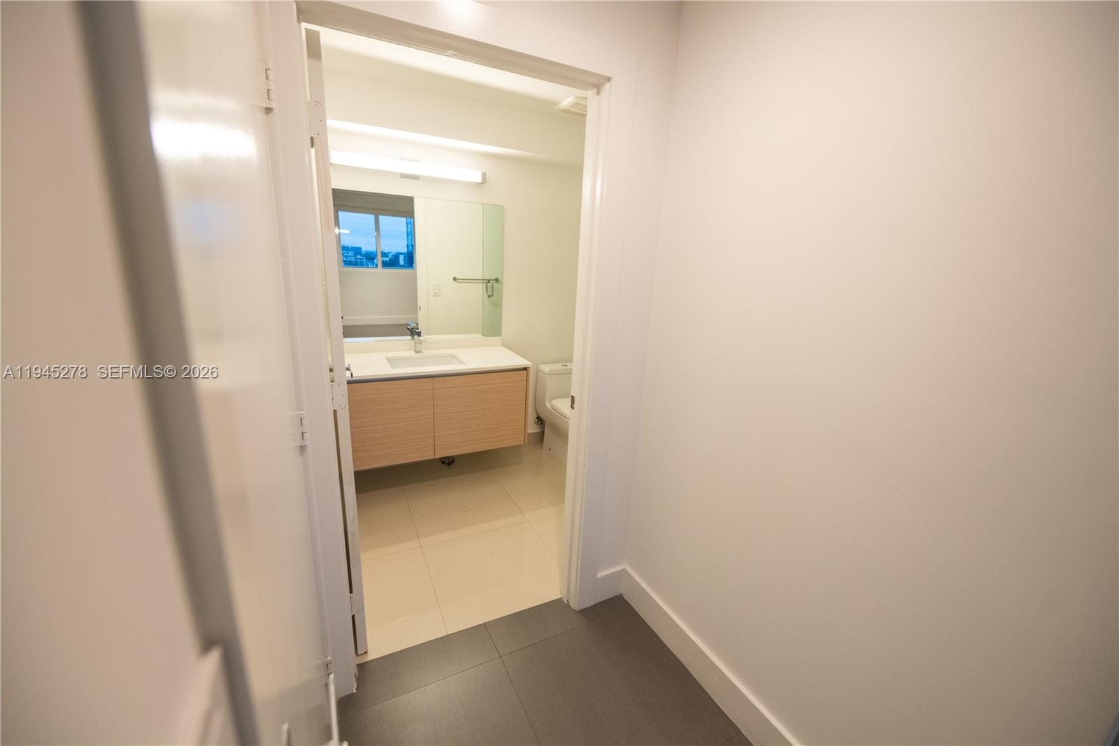 600 Northeast 27th Street, Unit 1602 Miami, FL 33137 - Photo 23 of 34 a bathroom with a sink and mirror with bathtub