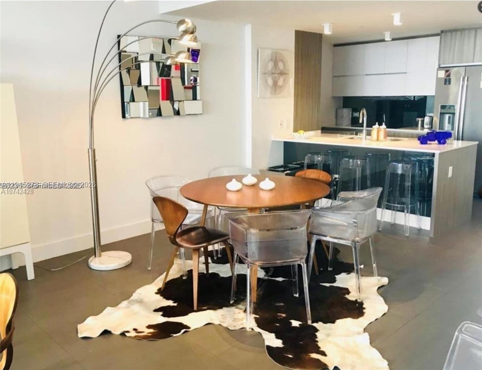 600 Northeast 27th Street, Unit 1602 Miami, FL 33137 - Photo 33 of 34 a dining room with furniture and wooden floor