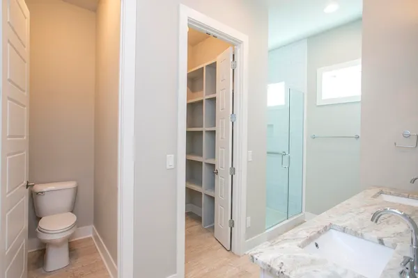 a bathroom with a granite countertop double vanity sink and a mirror