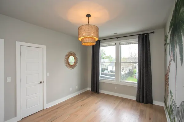 a view of hallway with furniture and a window