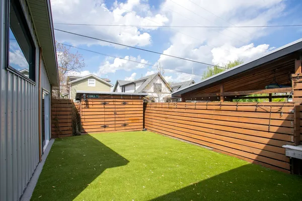 a view of an house with backyard space and porch