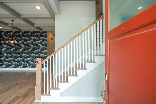 a view of a room with wooden floor