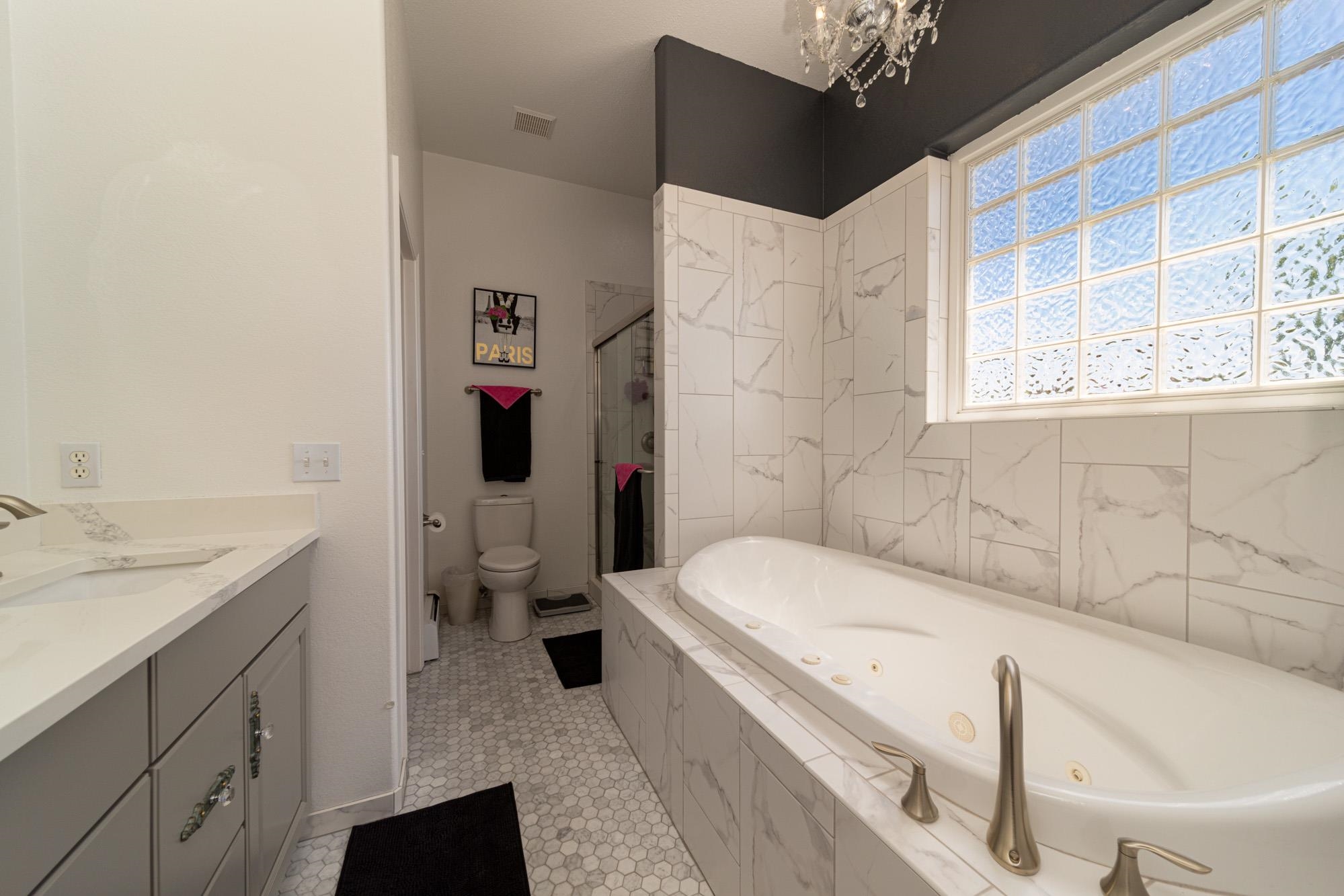 1668 M Road Fruita, CO 81521 - Photo 17 of 34 a bathroom with a granite countertop sink and a bathtub