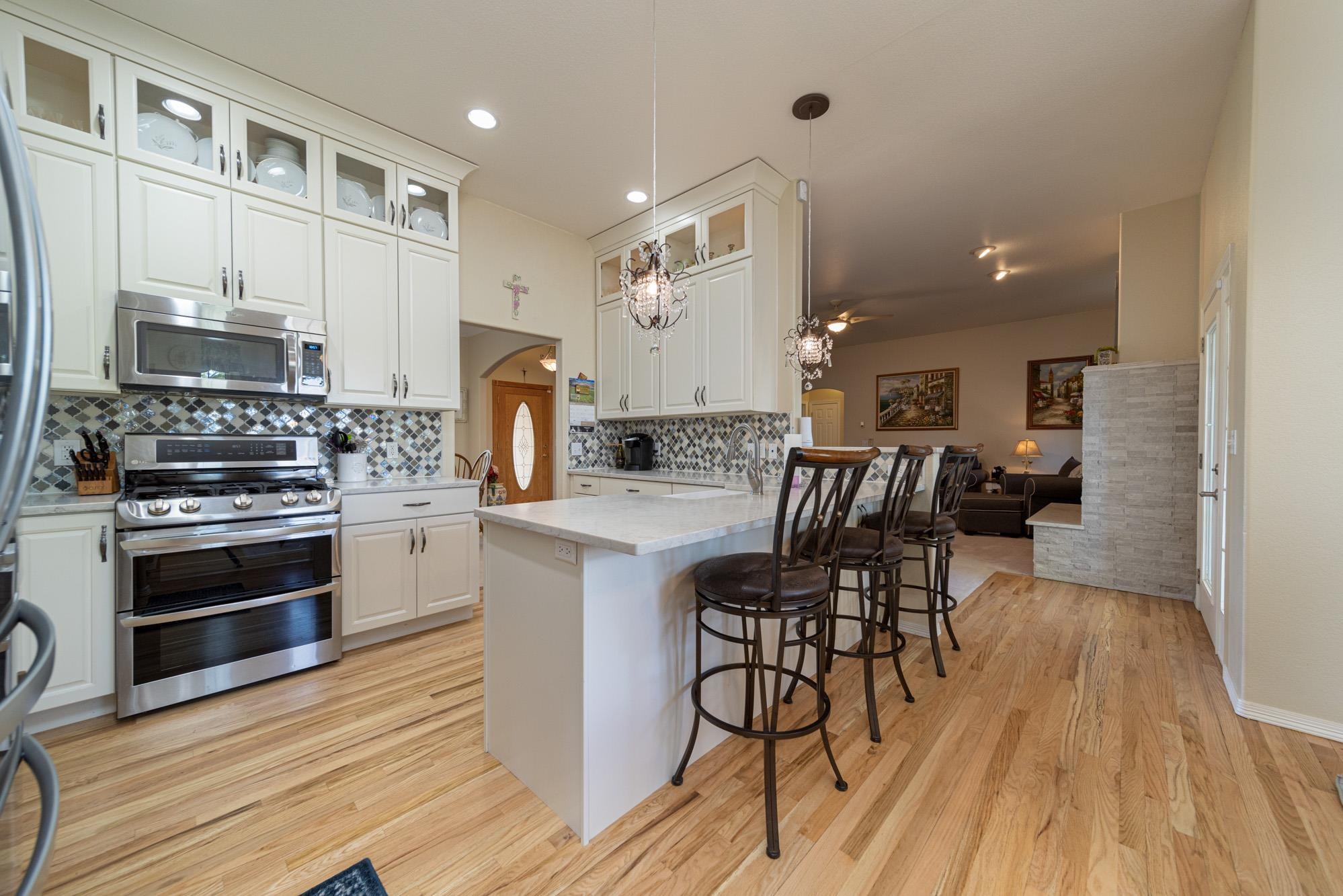 1668 M Road Fruita, CO 81521 - Photo 9 of 34 a kitchen with stainless steel appliances kitchen island granite countertop a stove a sink and a refrigerator