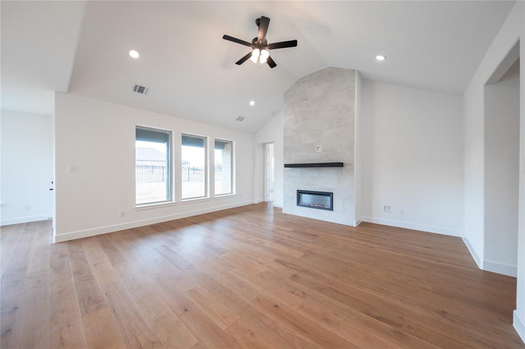 2715 Triumph Court Heath, TX 75126 - Photo 5 of 30 a view of empty room with wooden floor and fan