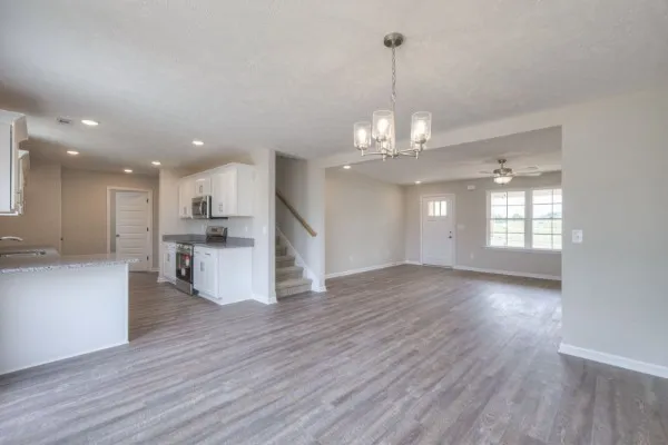 a view of a kitchen with stove and wooden floor