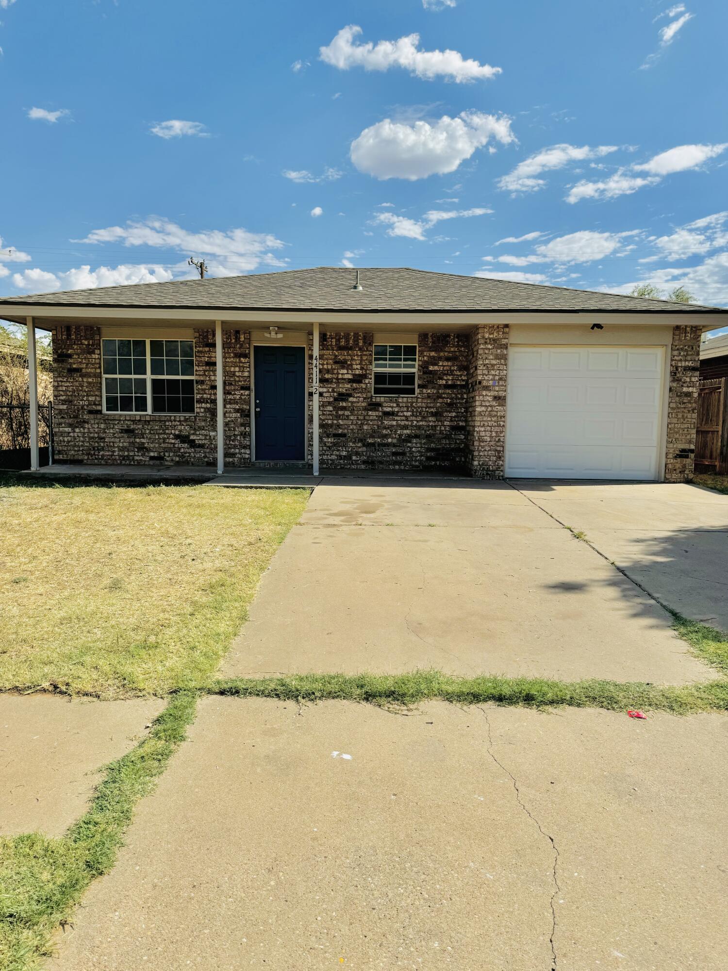 a front view of house with yard and ocean view