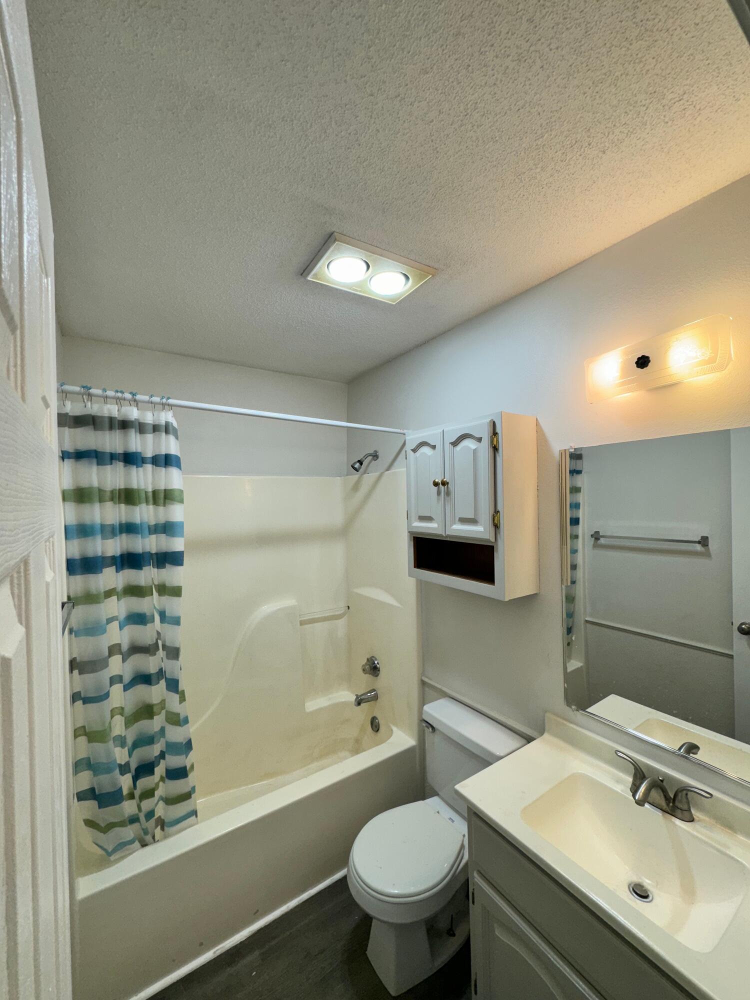 4411-2 Kemper Street Lubbock, TX 79416 - Photo 12 of 14 a bathroom with a sink toilet and shower