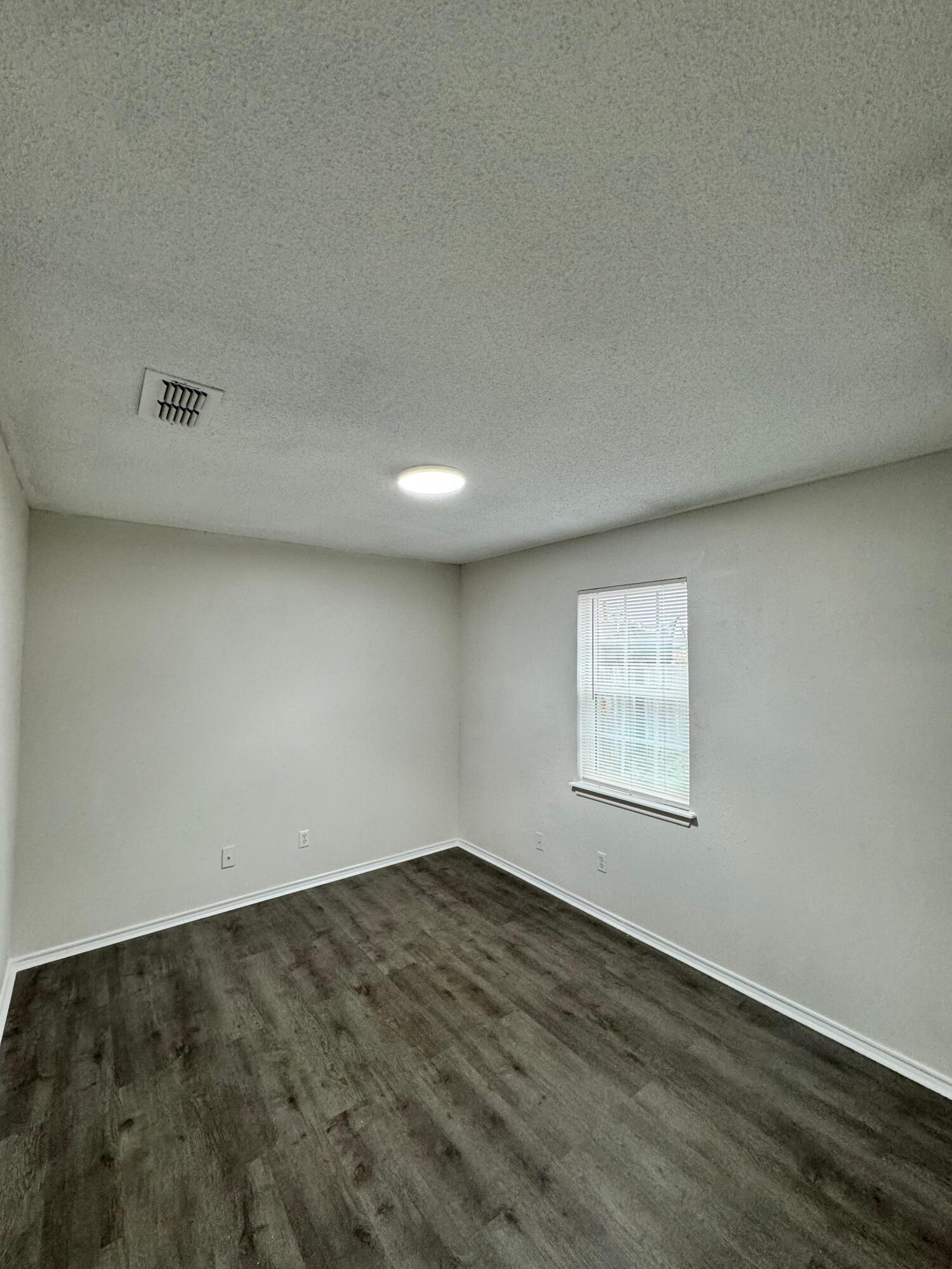 4411-2 Kemper Street Lubbock, TX 79416 - Photo 9 of 14 an empty room with a workbench