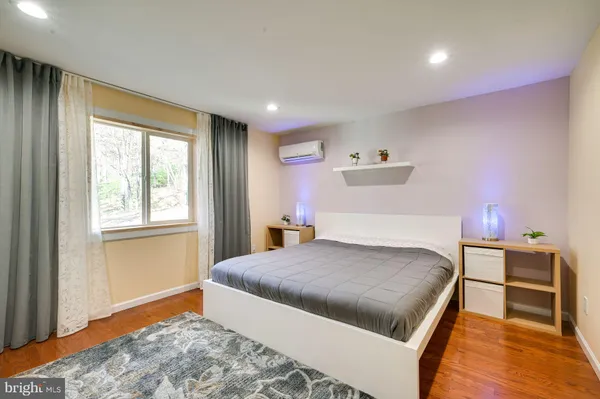 a bedroom with a large bed and a window