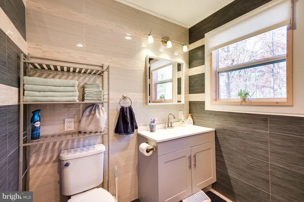 a bathroom with a sink a vanity and a mirror