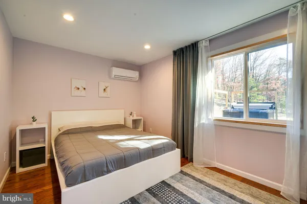 a bedroom with a large bed and a large window