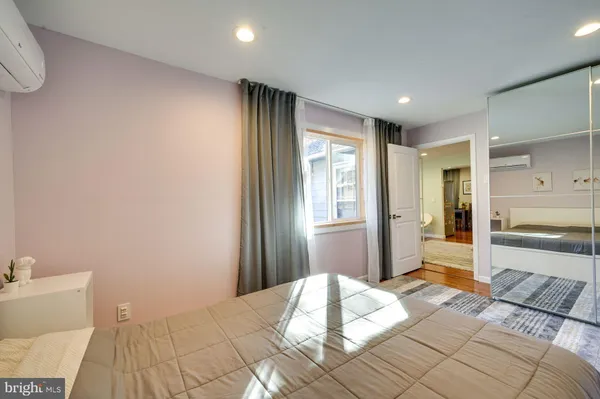 a bedroom with a bed and a large window