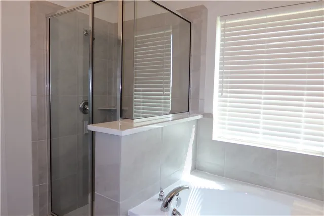 a bathroom with a bathtub and a window