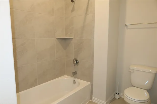 a bathroom with a bathtub and toilet