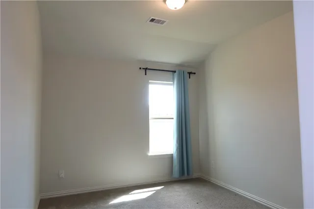 a view of an empty room and window