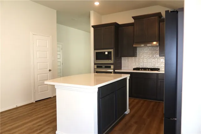a kitchen with a sink and a refrigerator
