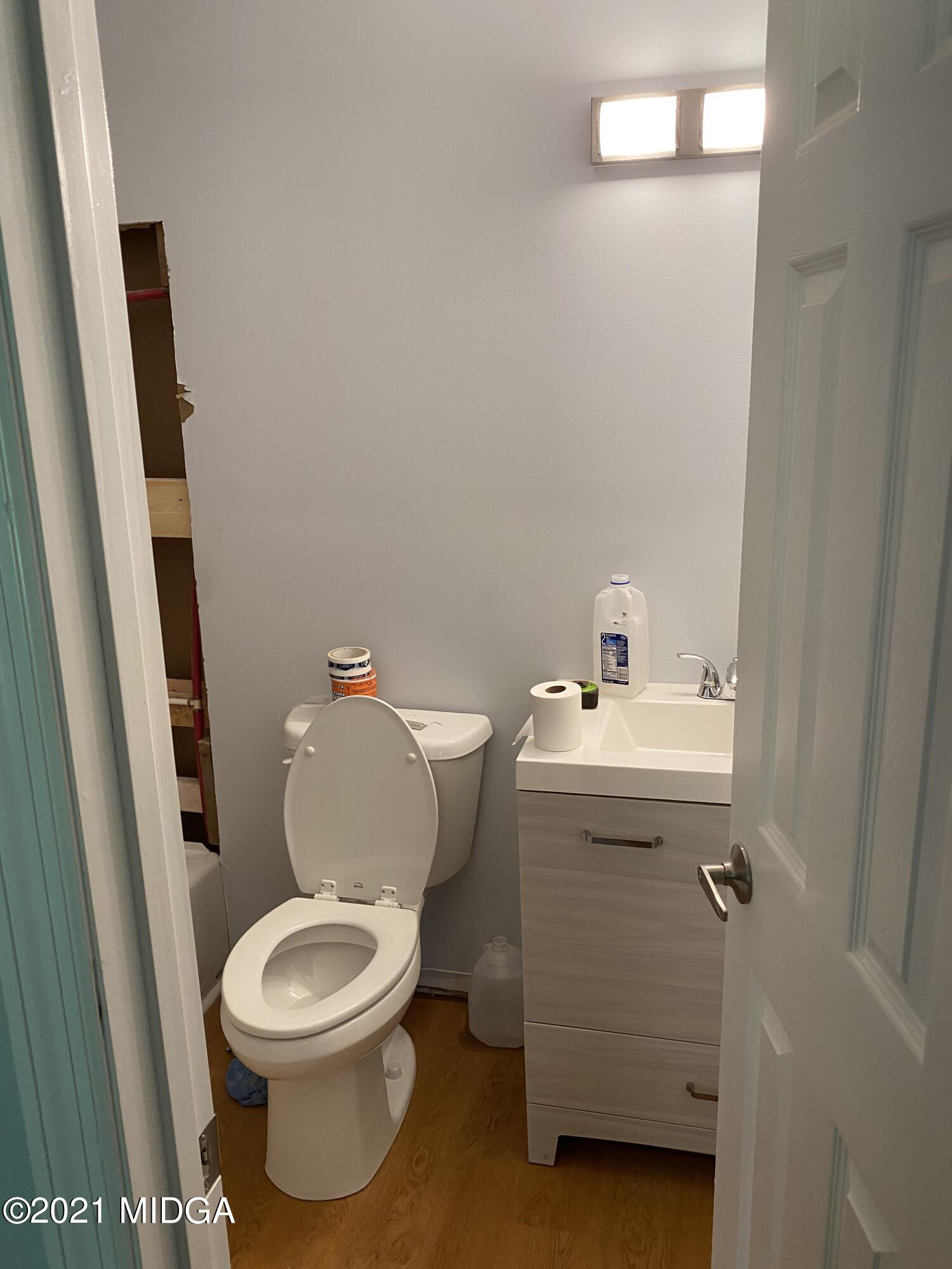 1351 Taylor Road Juliette, GA 31046 - Photo 7 of 14 a white toilet sitting next to a bathroom sink