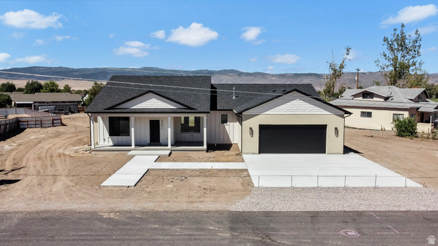 840 South Jones Road Monroe, UT 84754 - Photo 2 of 52 Contemporary exterior with a covered porch, board and batten siding, attached garage, concrete driveway, and concrete walkway