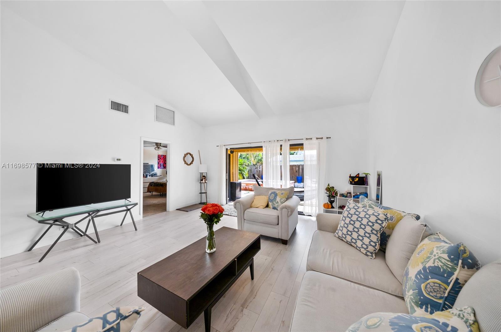 4440 Northeast 5th Avenue Boca Raton, FL 33431 - Photo 16 of 50 a living room with furniture and a flat screen tv