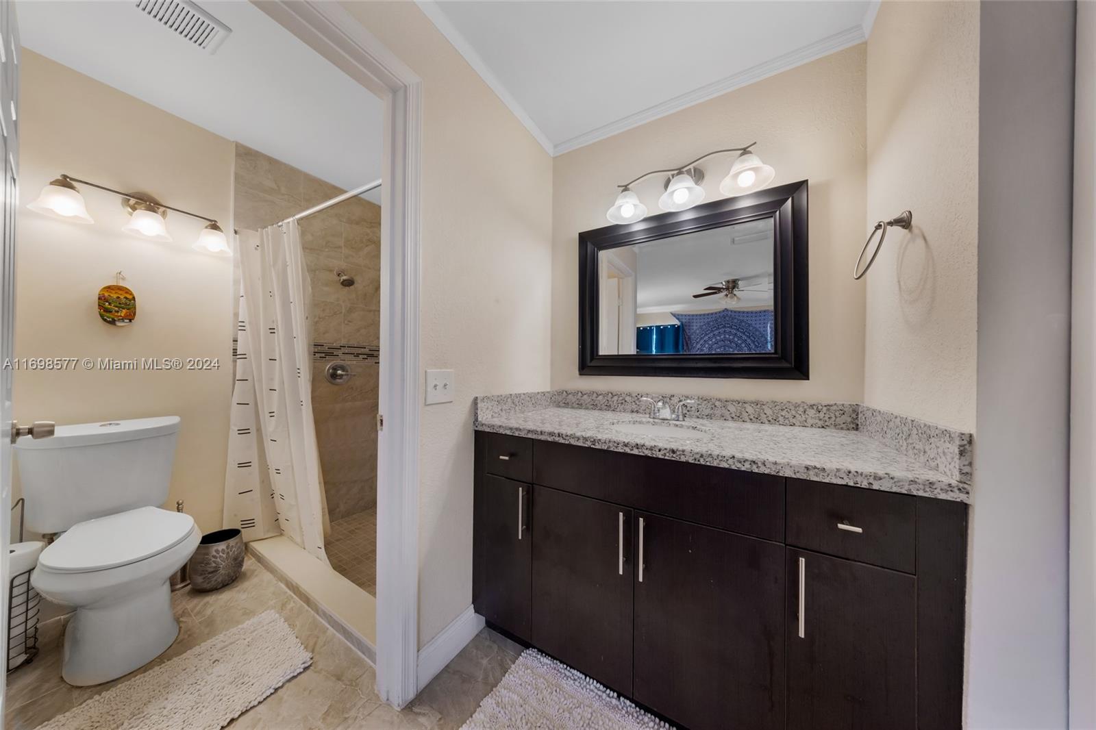 4440 Northeast 5th Avenue Boca Raton, FL 33431 - Photo 26 of 50 a bathroom with a toilet sink and mirror