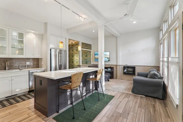 a kitchen with granite countertop a refrigerator and a sink