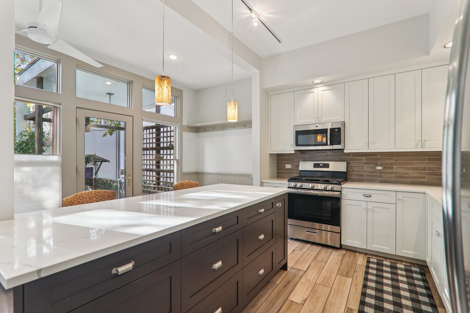 1027 West Newport Avenue Chicago, IL 60657 - Photo 13 of 36 a kitchen with stainless steel appliances granite countertop a stove a sink and a refrigerator