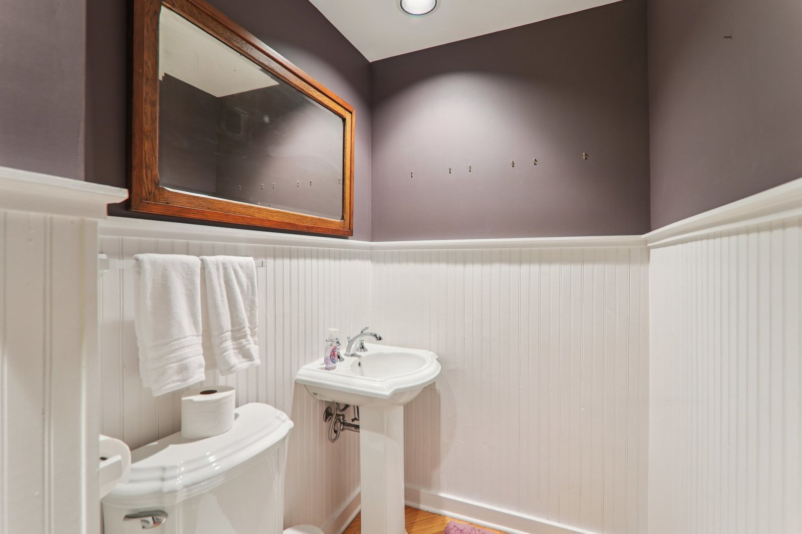 1027 West Newport Avenue Chicago, IL 60657 - Photo 18 of 36 a bathroom with a sink toilet and mirror