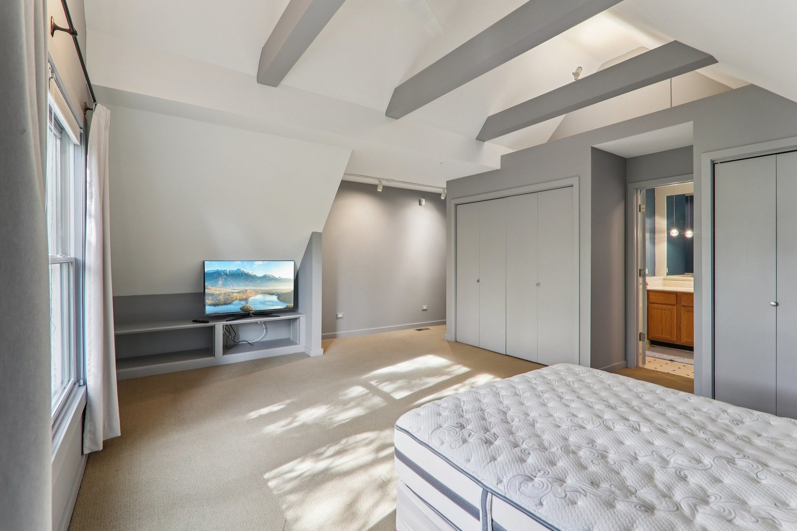 1027 West Newport Avenue Chicago, IL 60657 - Photo 24 of 36 a bedroom with a bed and a flat screen tv