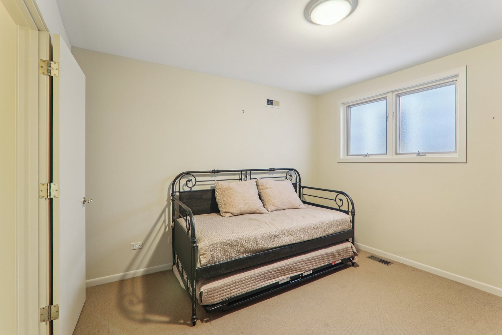 1027 West Newport Avenue Chicago, IL 60657 - Photo 27 of 36 a bed sitting in a bedroom next to a window