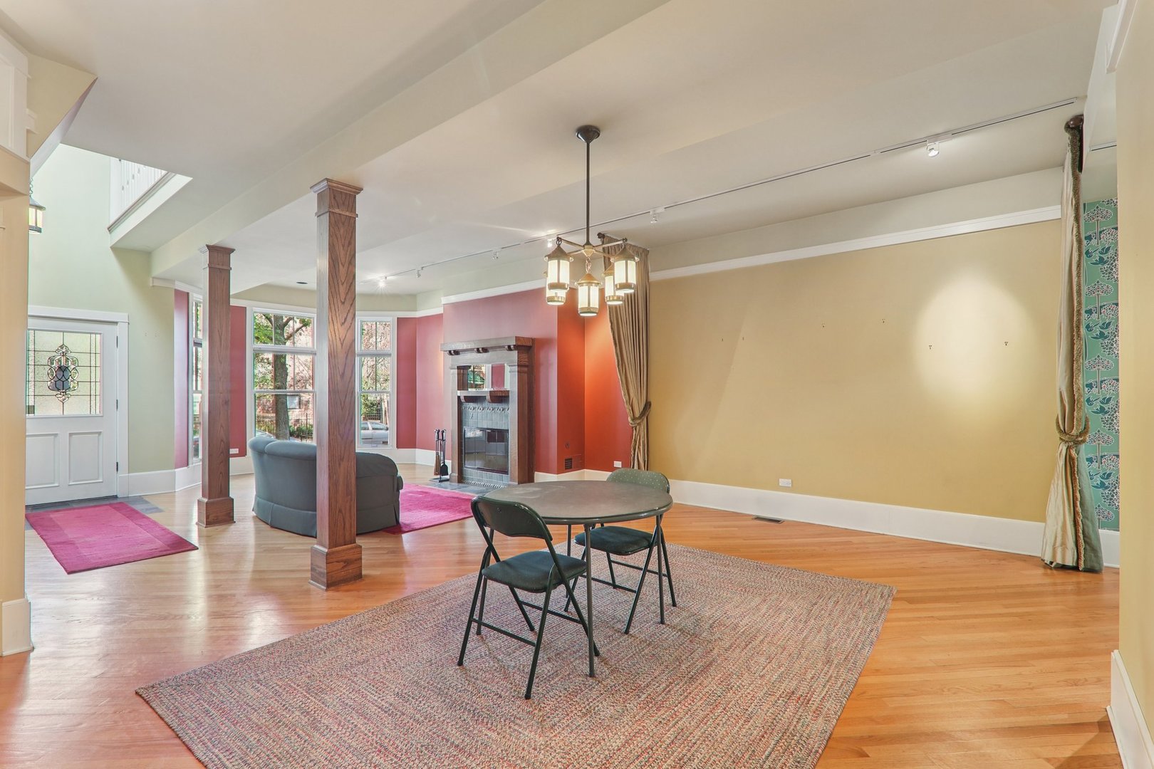 1027 West Newport Avenue Chicago, IL 60657 - Photo 8 of 36 a dining room with wooden floor a chandelier a glass table and chairs