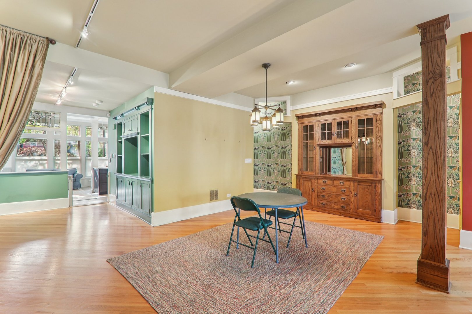 1027 West Newport Avenue Chicago, IL 60657 - Photo 10 of 36 a dining room with wooden floor a chandelier a glass table and chairs