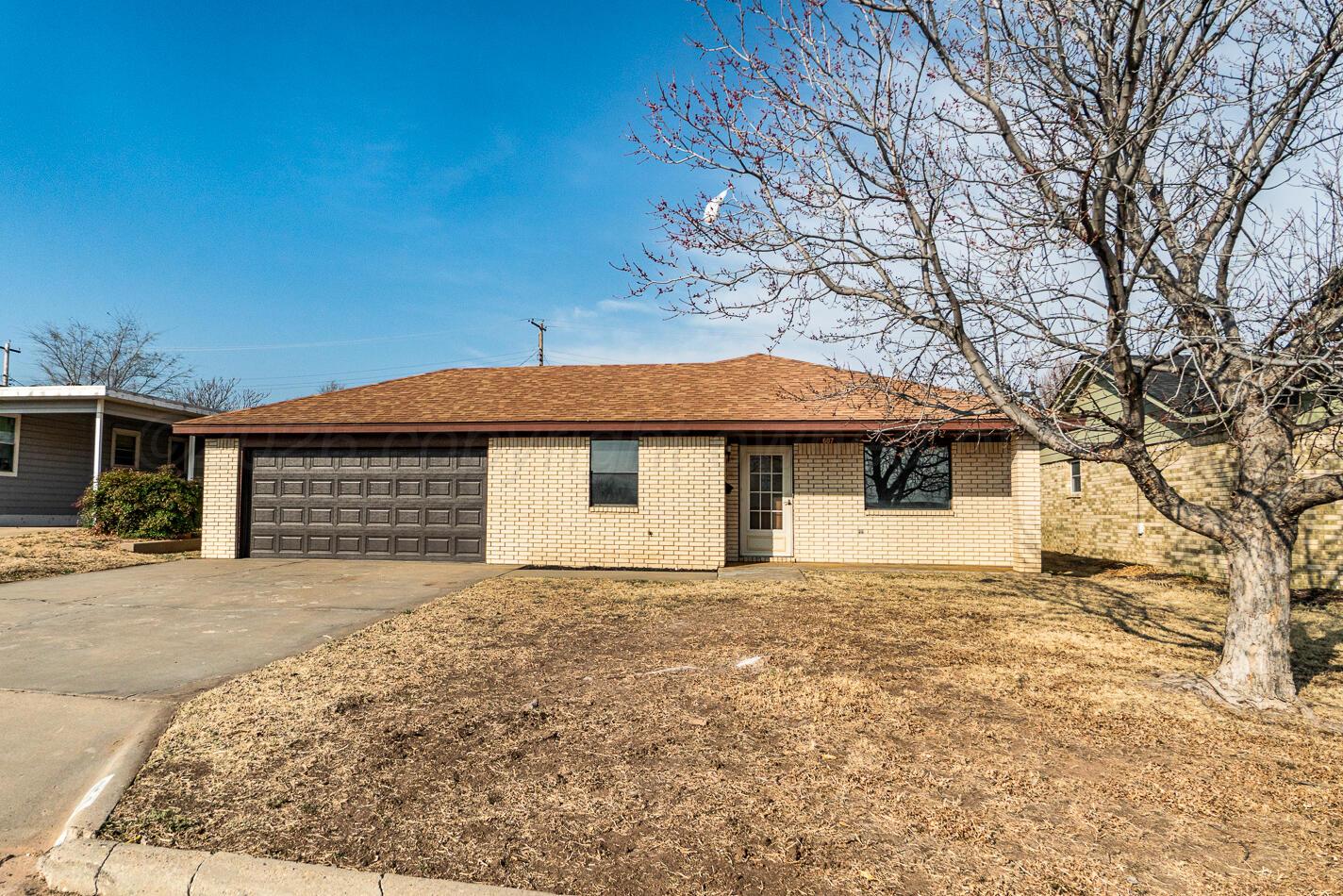 607 Mississippi Street Borger, TX 79007 - Photo 1 of 23 a front view of a house with a yard and garage