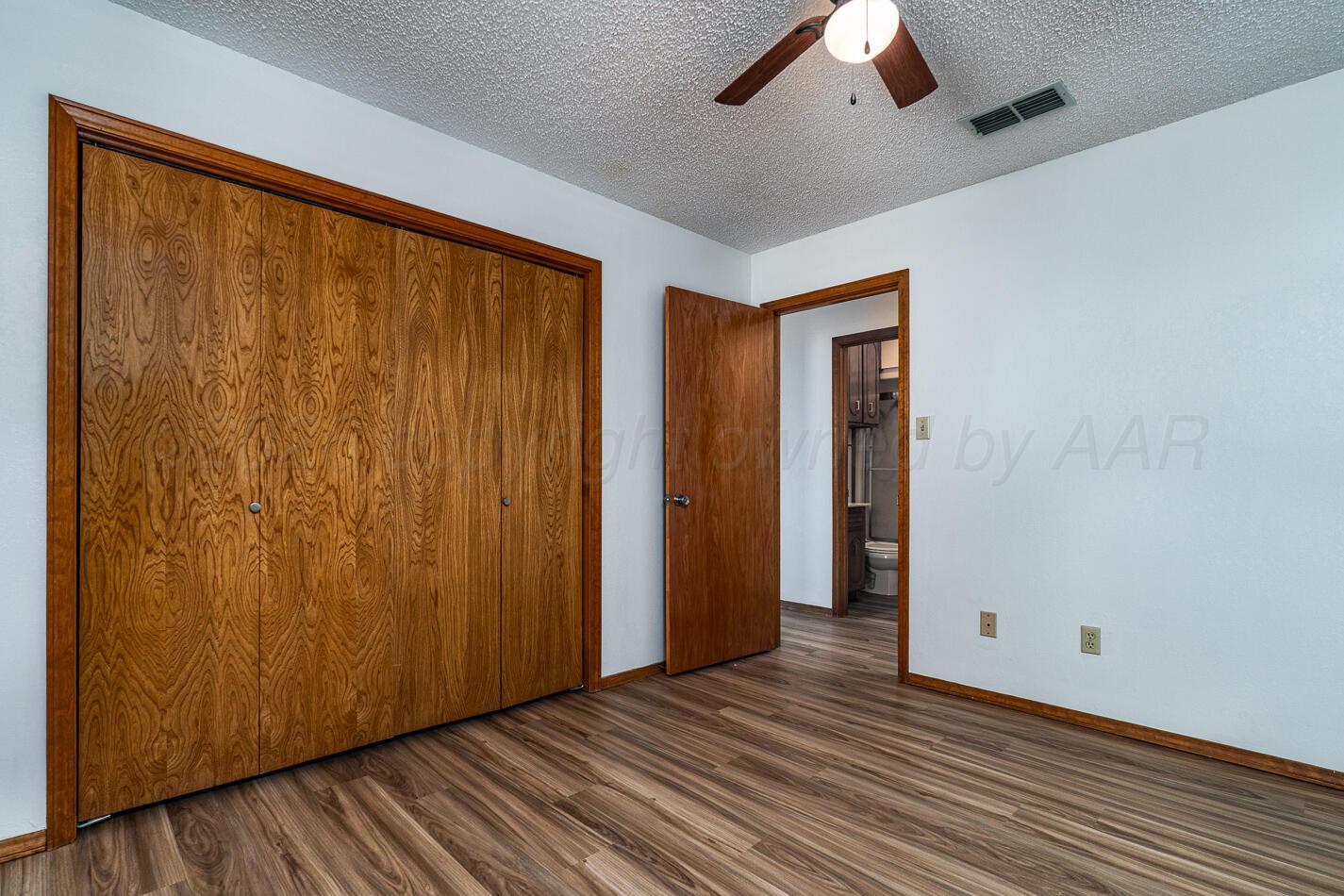 607 Mississippi Street Borger, TX 79007 - Photo 12 of 23 a view of an empty room with wooden floor and a window