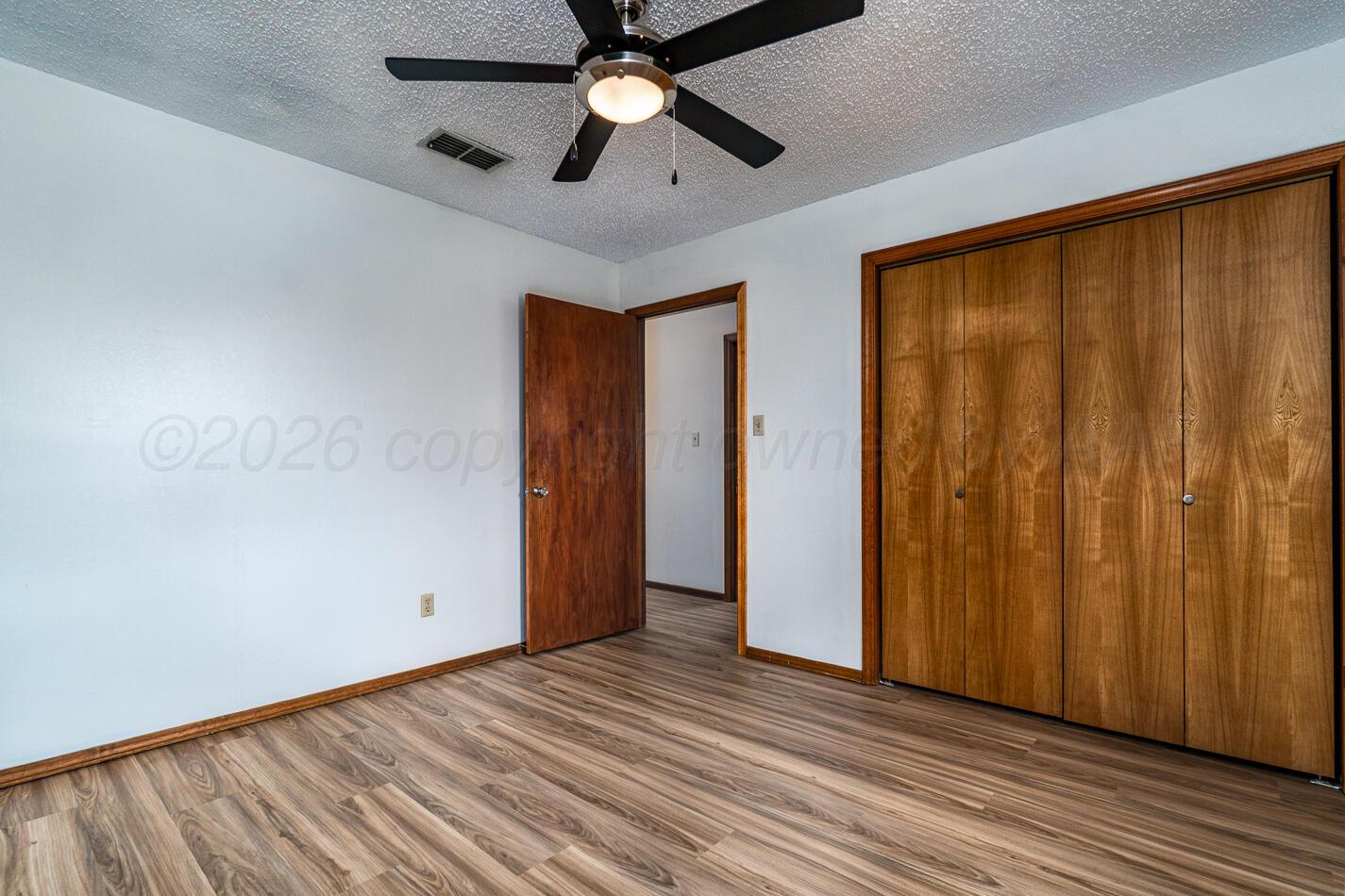 607 Mississippi Street Borger, TX 79007 - Photo 15 of 23 wooden floor in an empty room with a window