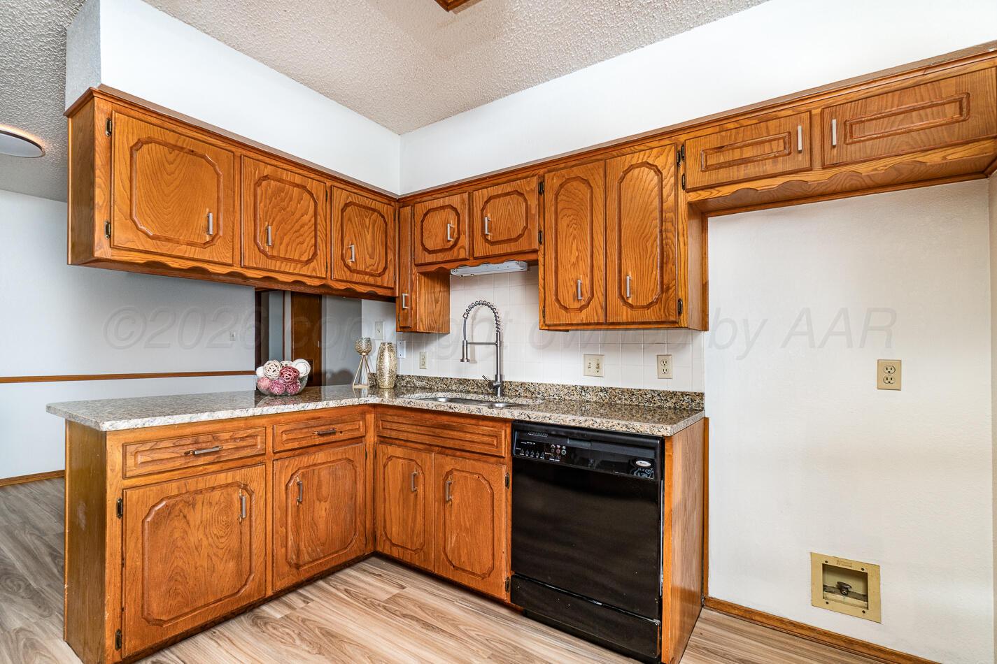 607 Mississippi Street Borger, TX 79007 - Photo 4 of 23 a kitchen with stainless steel appliances granite countertop a sink and cabinets