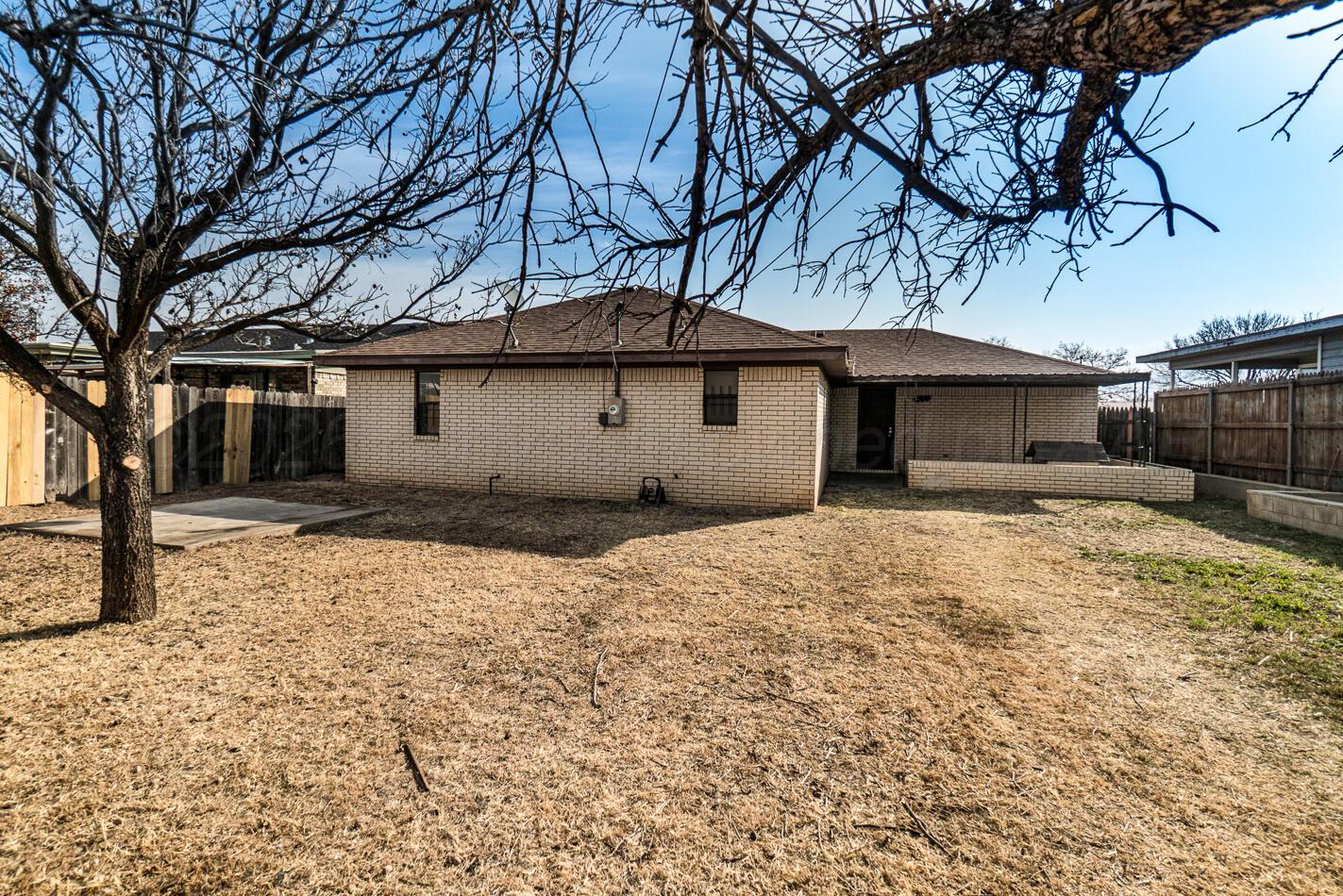 607 Mississippi Street Borger, TX 79007 - Photo 5 of 23 a house with a large tree in front of a house