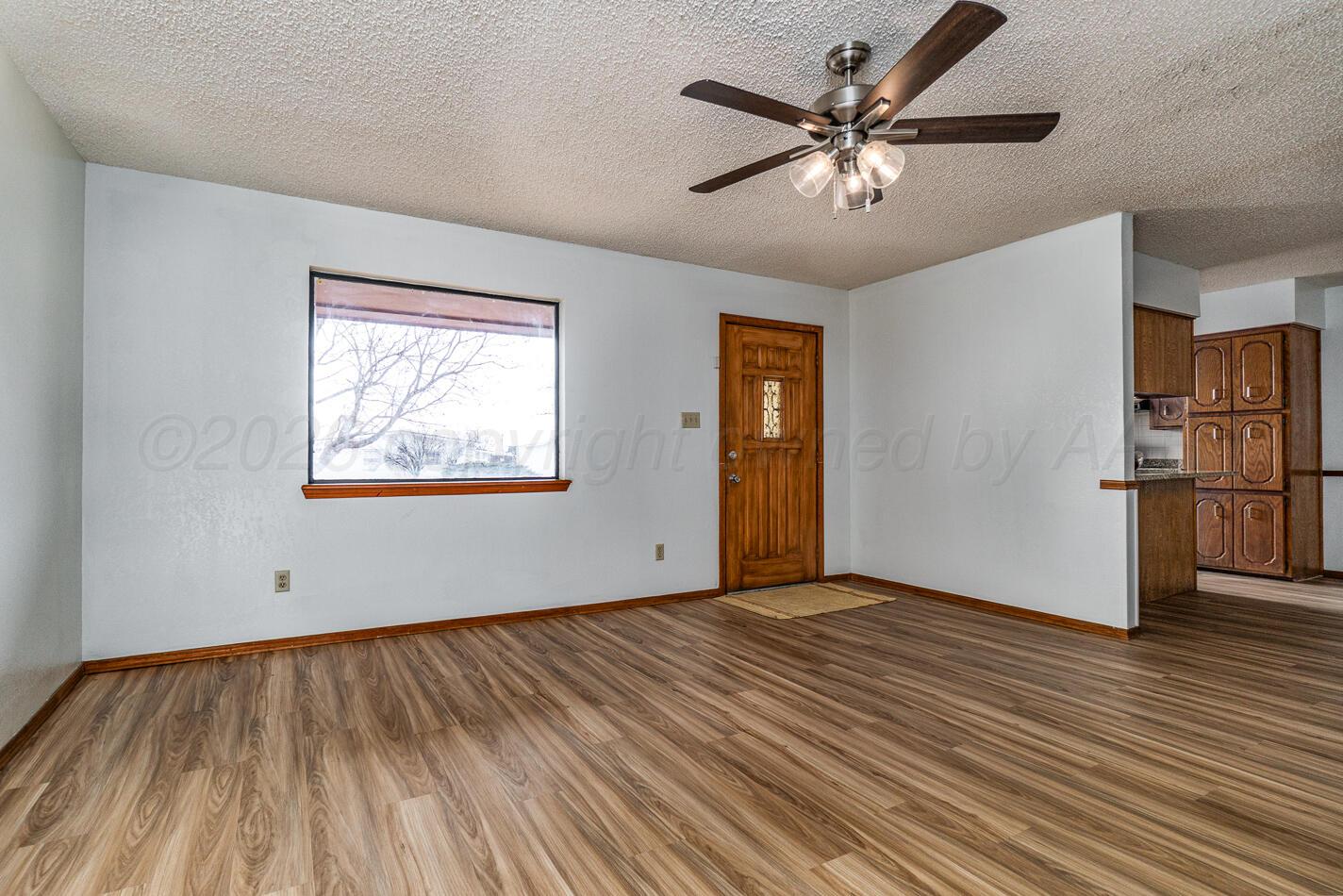 607 Mississippi Street Borger, TX 79007 - Photo 7 of 23 a view of empty room with wooden floor and ceiling fan