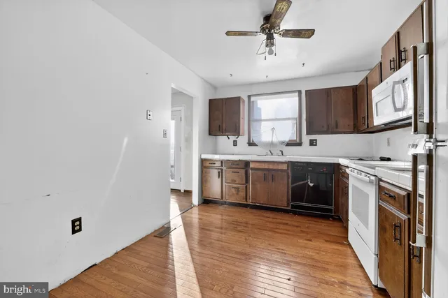 a kitchen with a white cabinets and white appliances