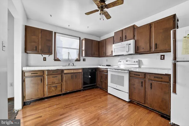 a kitchen with a stove a sink and a refrigerator