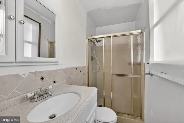 a view of room with window and wooden floor