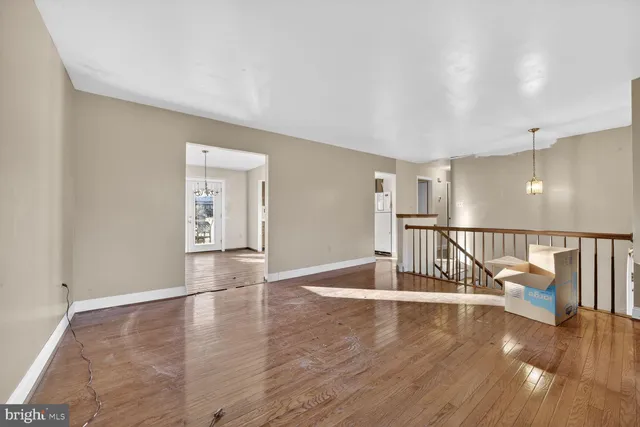 a view of a room with wooden floor and windows