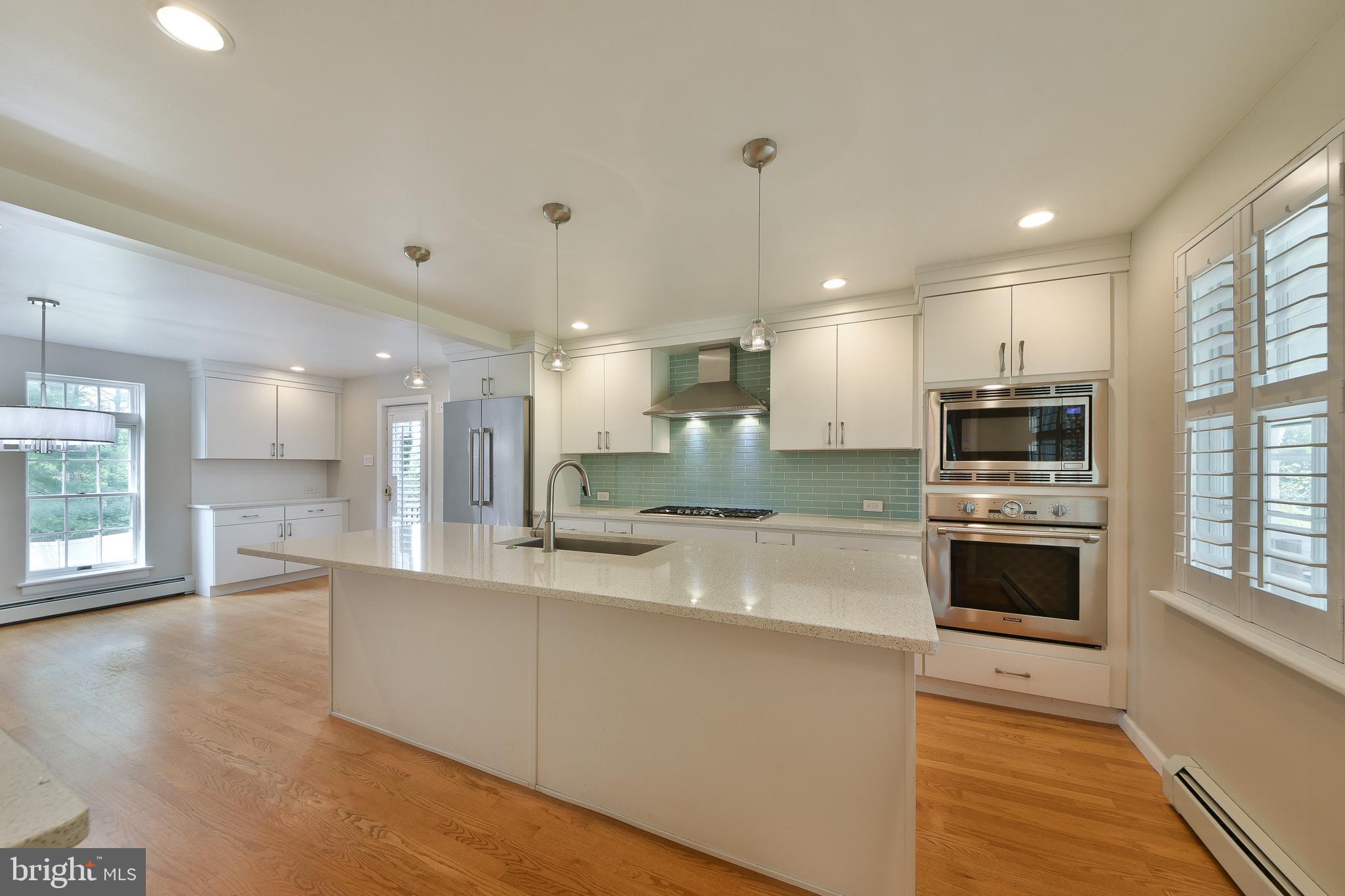 6113 West Mill Road Flourtown, PA 19031 - Photo 18 of 39 Kitchen with Quartz Counters & Tile Backsplash