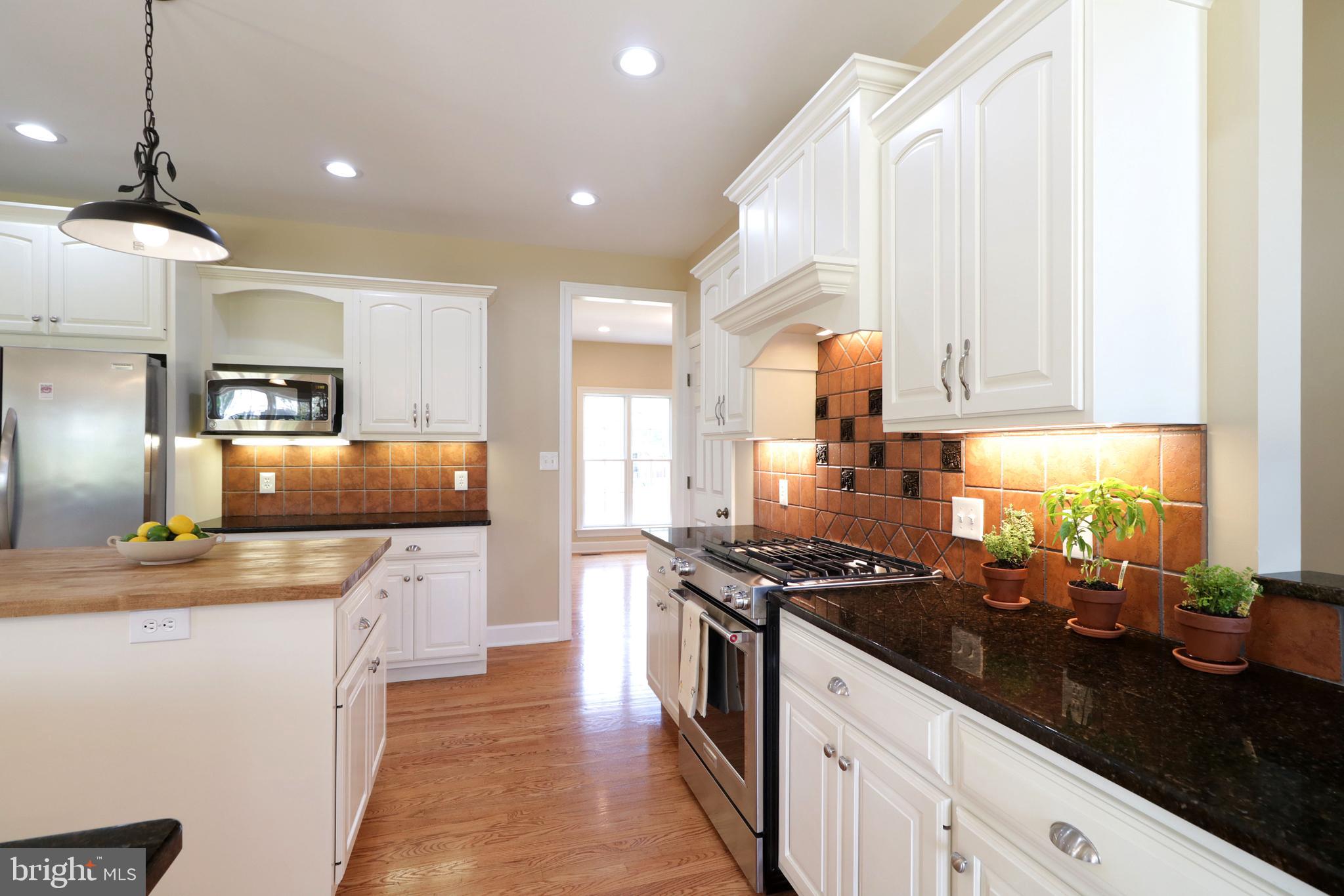 135 Fernleaf Court State College, PA 16801 - Photo 13 of 53 a kitchen with stainless steel appliances granite countertop a sink a stove and a refrigerator